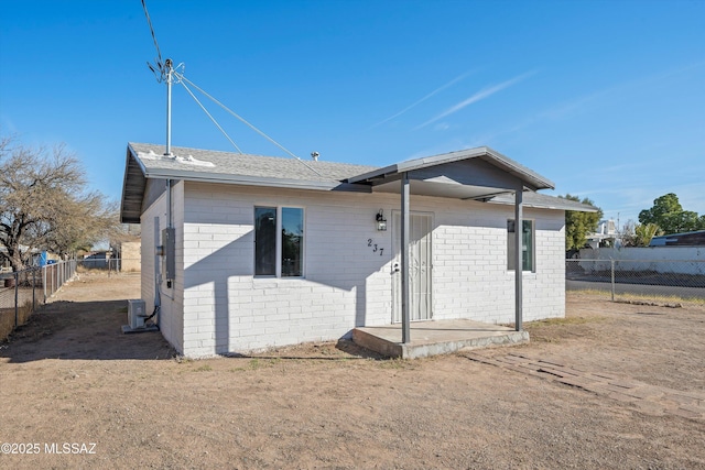 view of front of property with cooling unit and fence