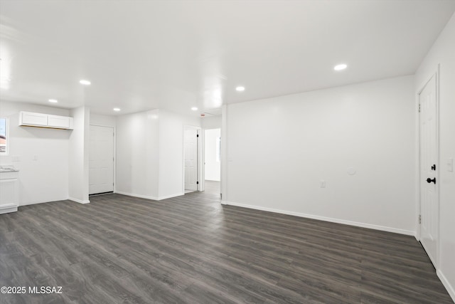 unfurnished living room featuring dark wood-style floors, baseboards, and recessed lighting