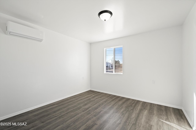 unfurnished room featuring dark wood-style floors, a wall unit AC, and baseboards