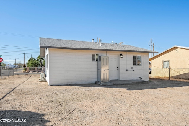 back of property featuring fence