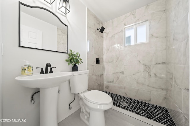 bathroom with toilet and a shower stall