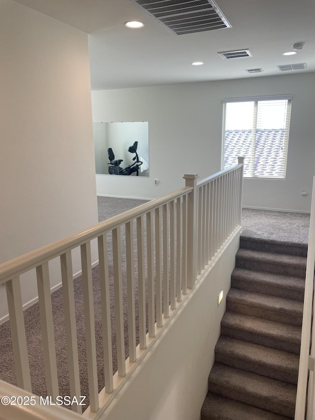 stairway with carpet floors, visible vents, baseboards, and recessed lighting