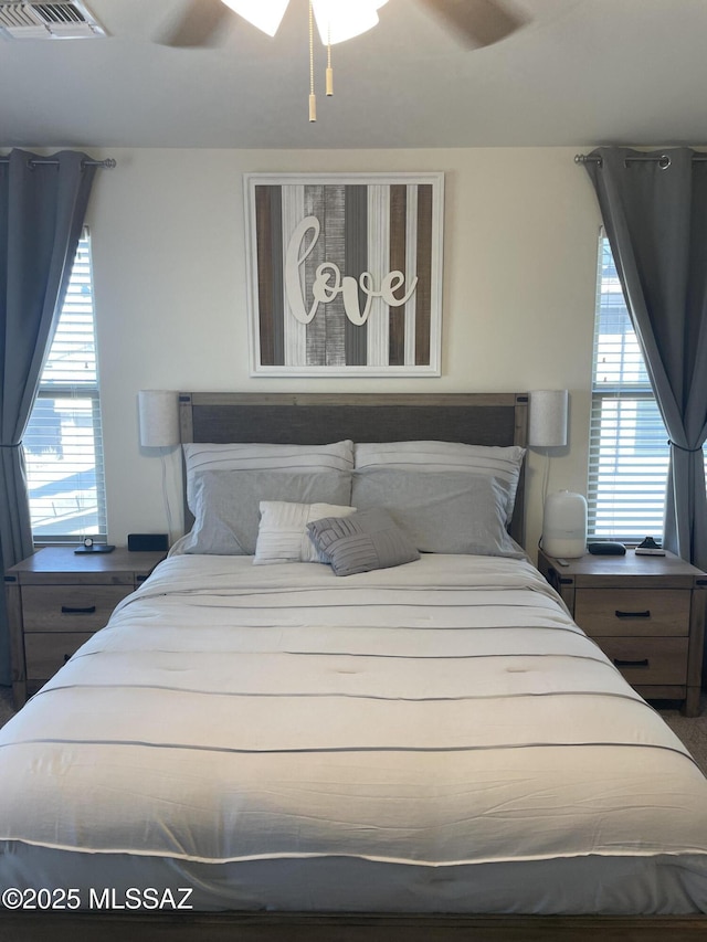 bedroom featuring visible vents and ceiling fan