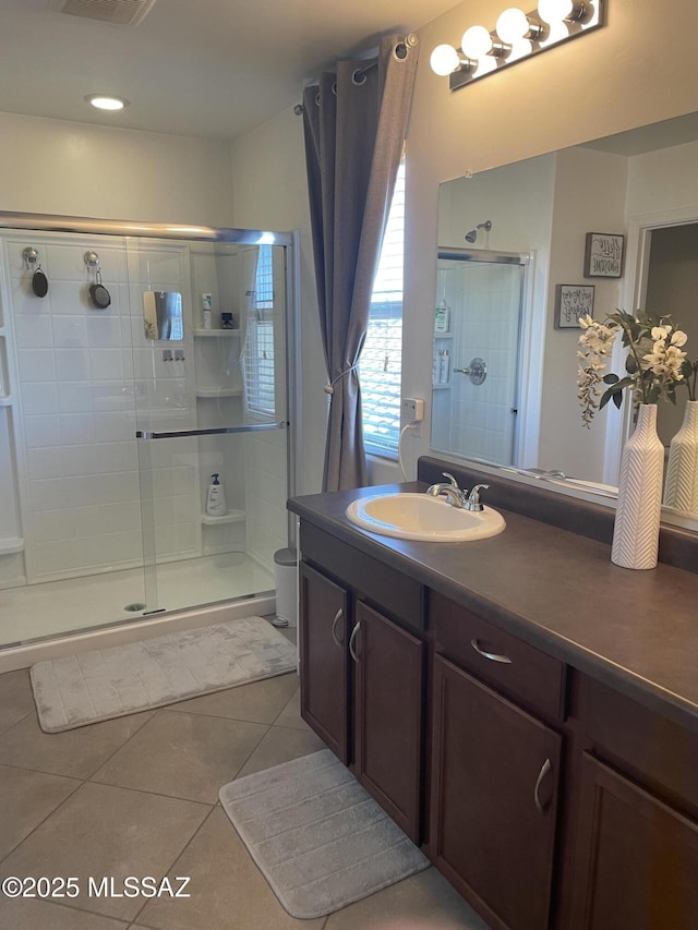 full bathroom with visible vents, a stall shower, tile patterned flooring, and vanity