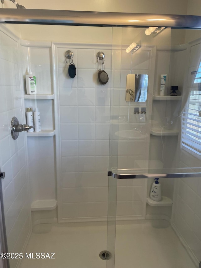 full bath with a shower stall