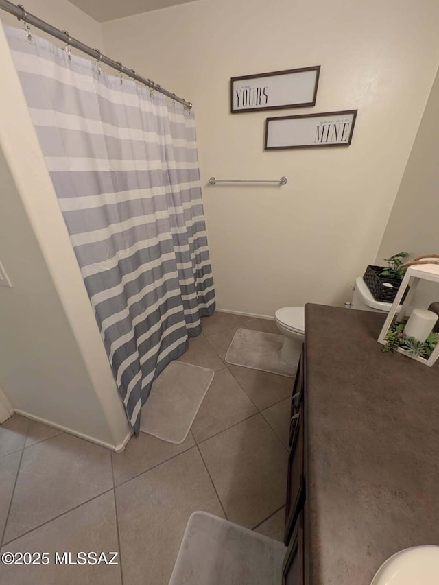 bathroom with vanity, curtained shower, tile patterned flooring, and toilet