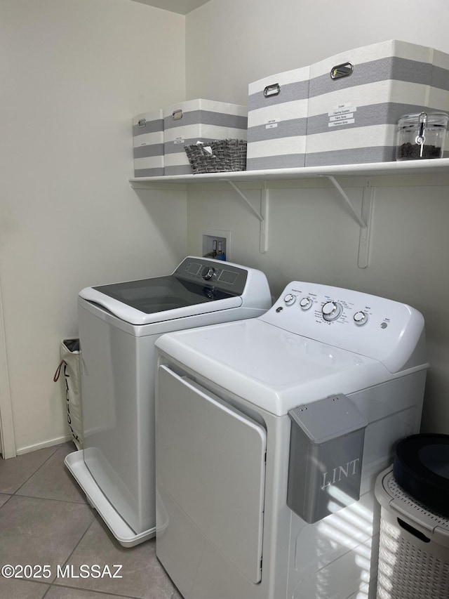 laundry room featuring laundry area, light tile patterned flooring, and washer and dryer