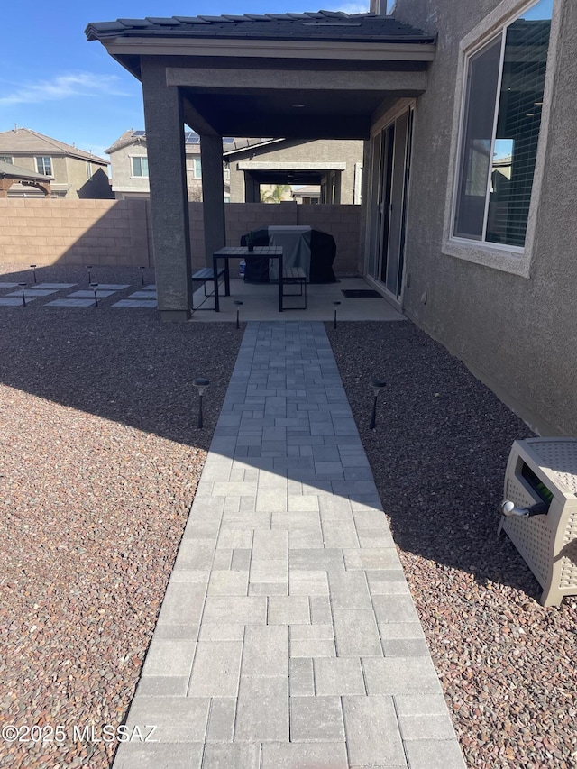 view of patio / terrace with a fenced backyard and a grill