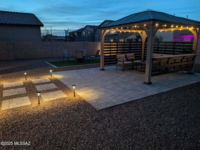 exterior space featuring an outdoor hangout area, a gazebo, and fence