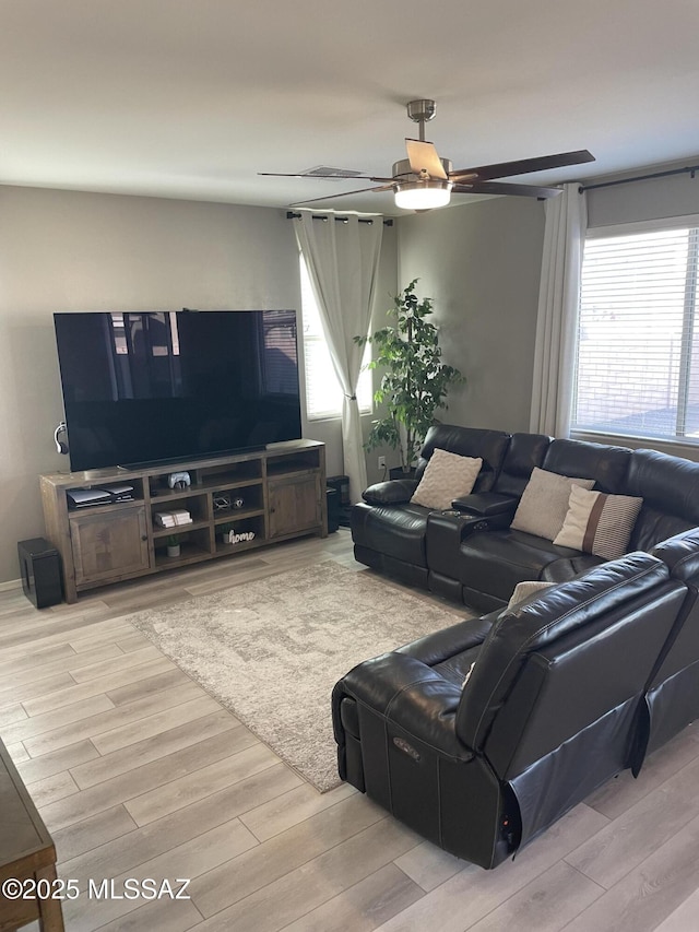 living room with ceiling fan and wood finished floors