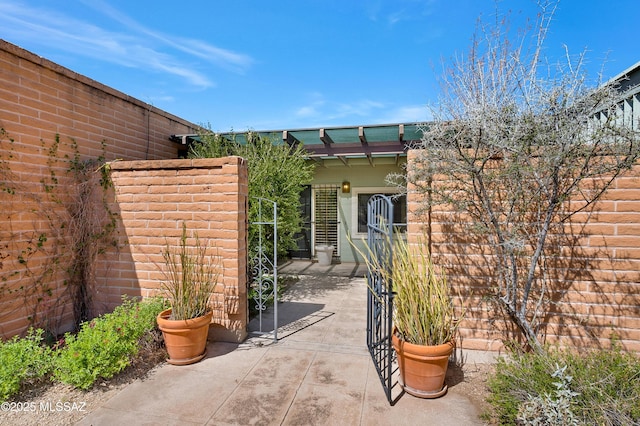 property entrance featuring a patio area