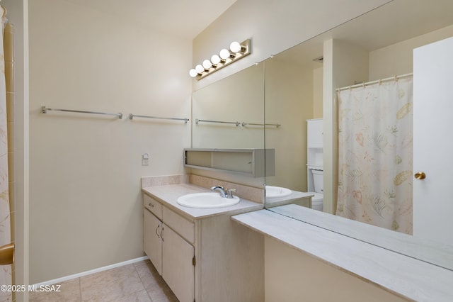 bathroom featuring vanity, a shower with shower curtain, baseboards, and tile patterned flooring