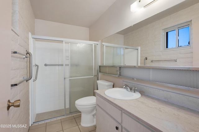 full bathroom featuring tile patterned flooring, a shower stall, toilet, and vanity