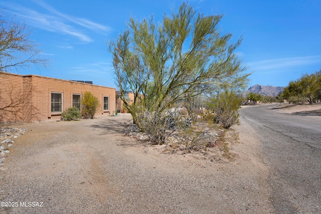 view of front of house with a mountain view and driveway