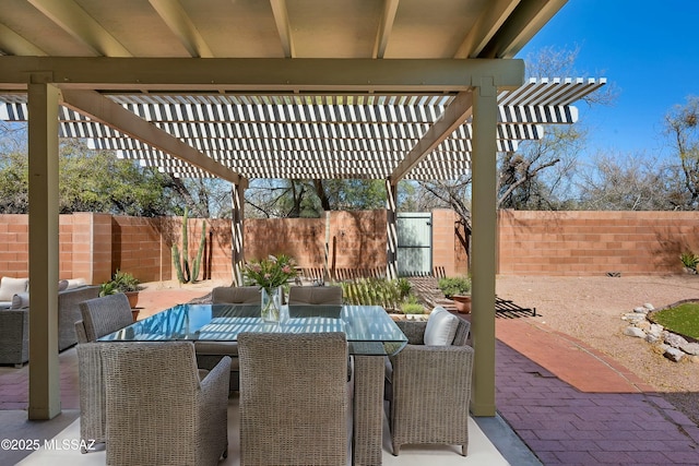 view of patio featuring outdoor dining area, a fenced backyard, and a pergola