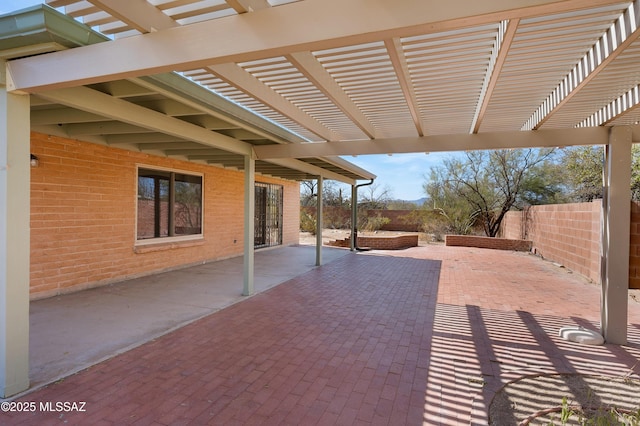 view of patio / terrace with a pergola and fence