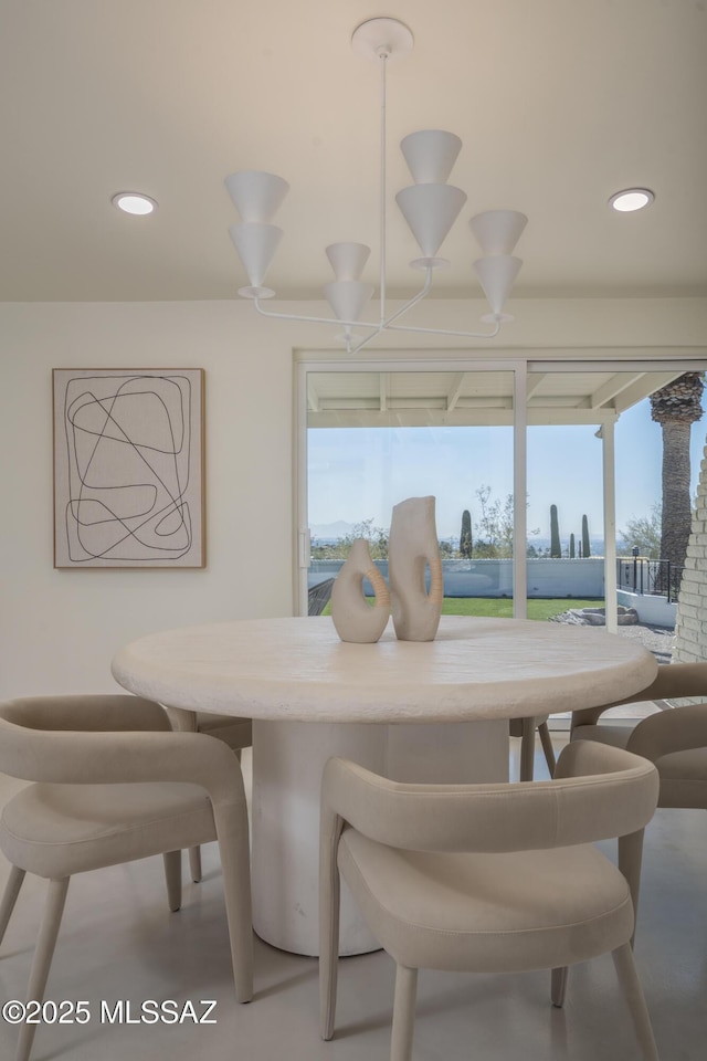 dining area with recessed lighting and a notable chandelier