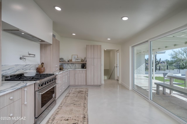 kitchen featuring high end stove, premium range hood, modern cabinets, and recessed lighting