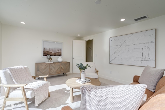 living room featuring baseboards, visible vents, light colored carpet, and recessed lighting