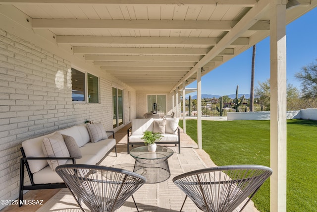 view of patio / terrace featuring a mountain view and an outdoor hangout area