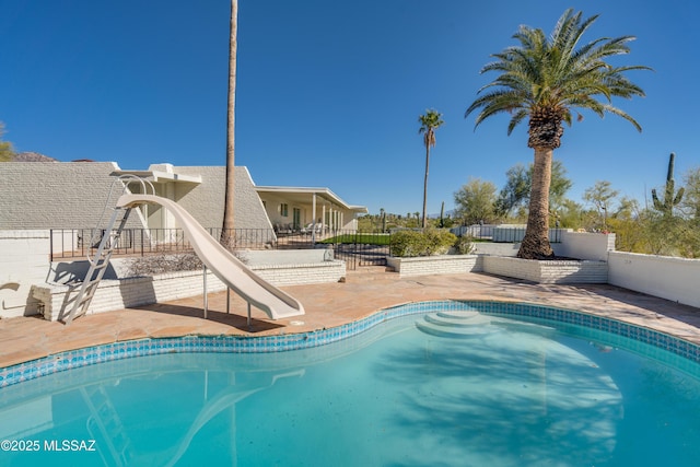 view of pool featuring a fenced in pool, a water slide, a patio area, and fence