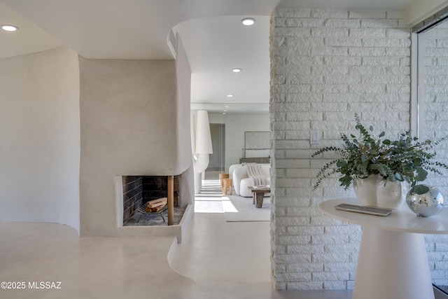 interior space featuring recessed lighting, concrete floors, and a multi sided fireplace