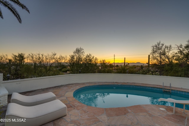 outdoor pool featuring a water slide and a patio