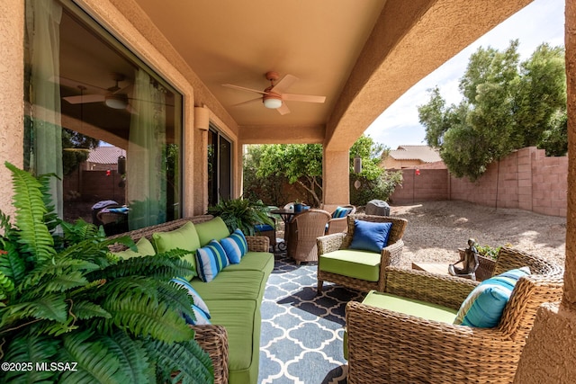 view of patio with a fenced backyard, ceiling fan, and an outdoor living space