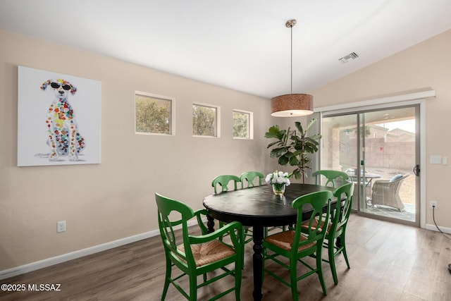 dining space featuring plenty of natural light, wood finished floors, and visible vents