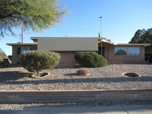 view of front of property featuring brick siding