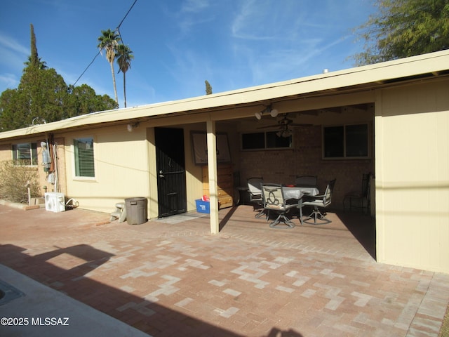 back of property featuring a patio area and outdoor dining area