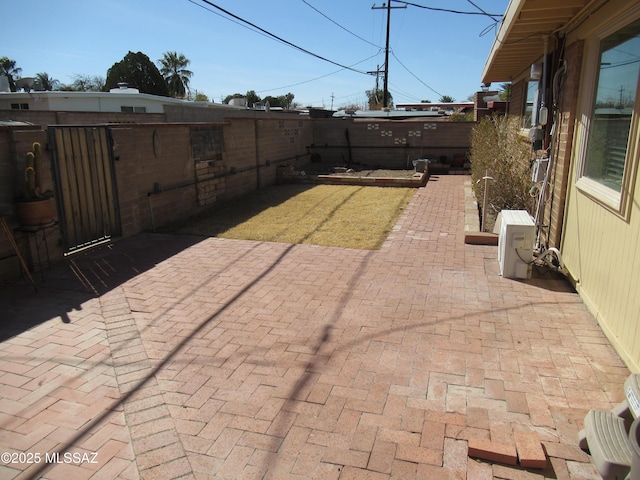 view of patio with ac unit and a fenced backyard