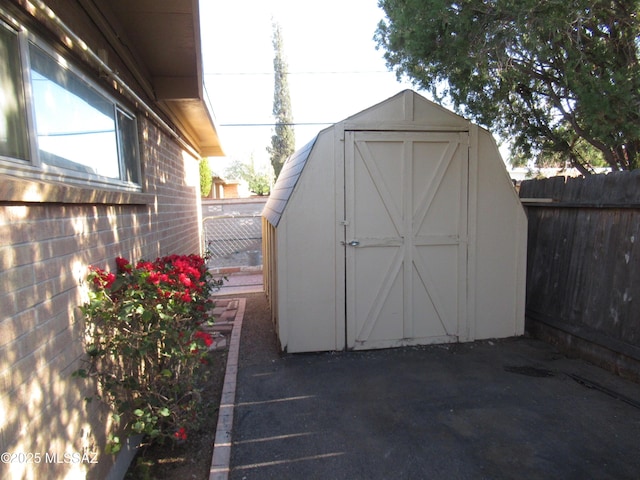 view of shed featuring fence