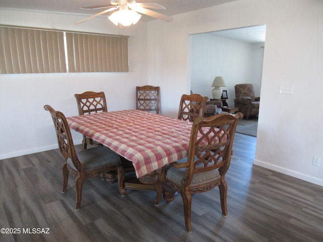 dining area featuring wood finished floors, a ceiling fan, and baseboards