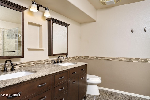 full bathroom with visible vents, a sink, baseboards, and double vanity