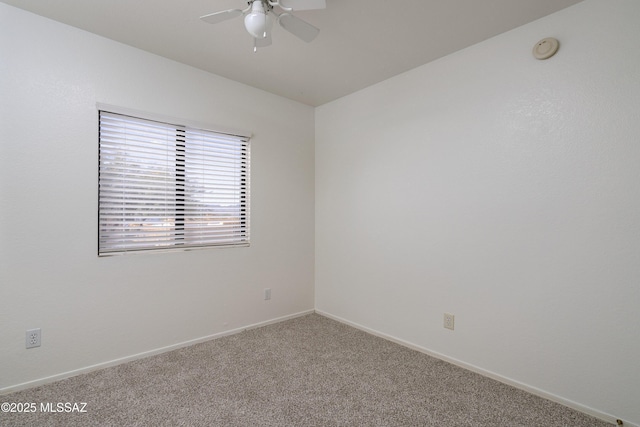 unfurnished room featuring ceiling fan, carpet floors, and baseboards