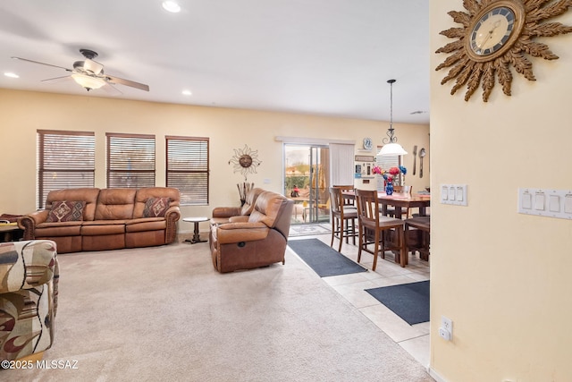 living area with light tile patterned floors, ceiling fan, light colored carpet, and recessed lighting