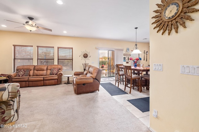 13076 N Desert Olive Dr, Oro Valley, AZ 85755 - living room with light tile patterned flooring, light colored carpet, ceiling fan, and recessed lighting