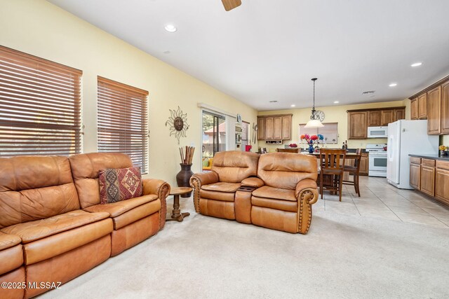 living area featuring light tile patterned floors, light carpet, and recessed lighting