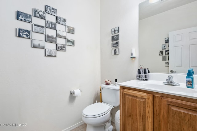 half bath with vanity, toilet, and tile patterned floors