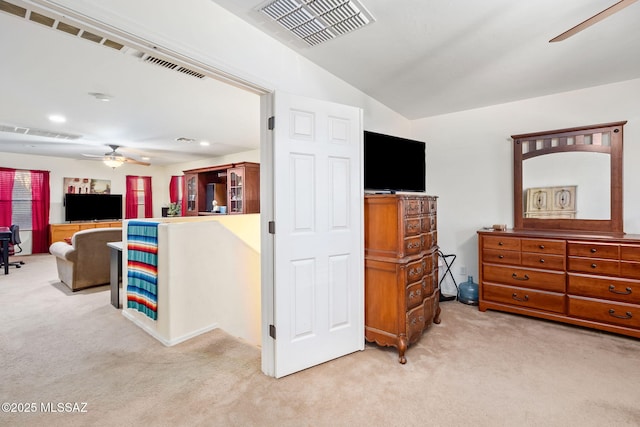 interior space with carpet, visible vents, and vaulted ceiling