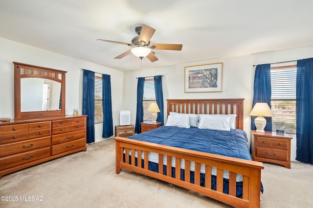 bedroom with light carpet and ceiling fan