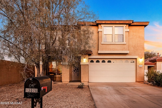 13076 N Desert Olive Dr, Oro Valley, AZ 85755 - view of front of house featuring concrete driveway, stucco siding, and an attached garage