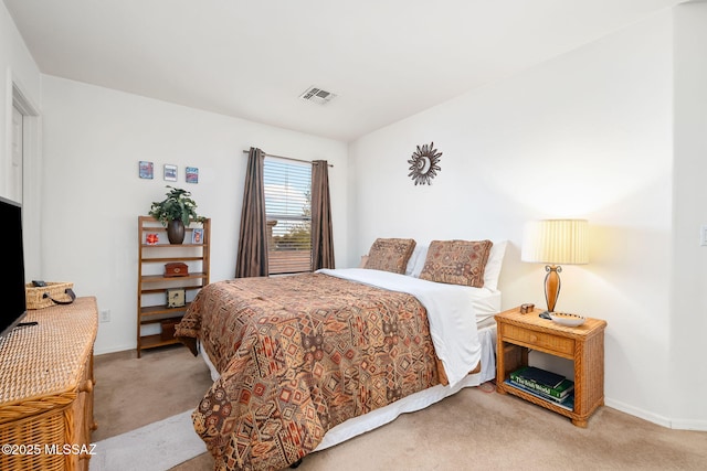 bedroom with light carpet, visible vents, and baseboards