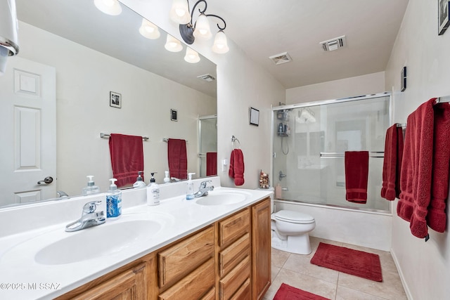 bathroom with visible vents, a sink, and tile patterned floors