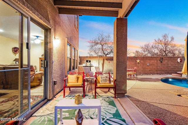 patio terrace at dusk with a fenced backyard