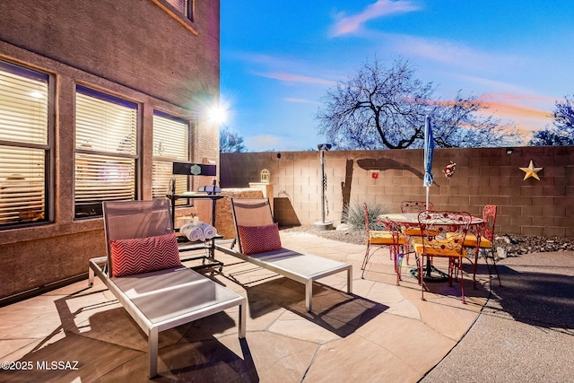 view of patio featuring fence and outdoor dining area