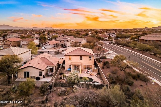 aerial view at dusk with a residential view and a mountain view