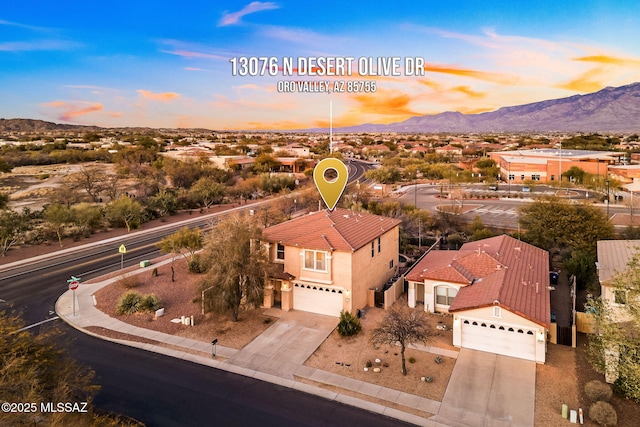 13076 N Desert Olive Dr, Oro Valley, AZ 85755 - aerial view at dusk with a mountain view
