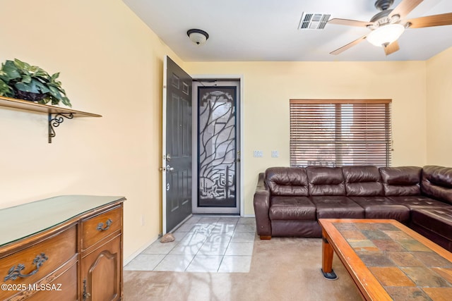 living room featuring ceiling fan and visible vents